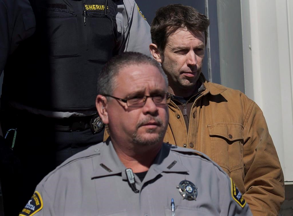 John Mark Tillmann, right, charged with possession of stolen property, is escorted by sheriffs from provincial court in Dartmouth on Wednesday, Feb. 27, 2013.