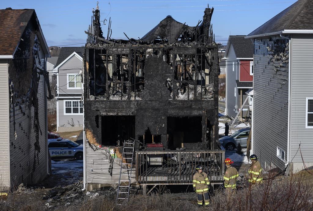 Firefighters investigate following a house fire in the Spryfield community in Halifax on Tuesday, February 19, 2019.
