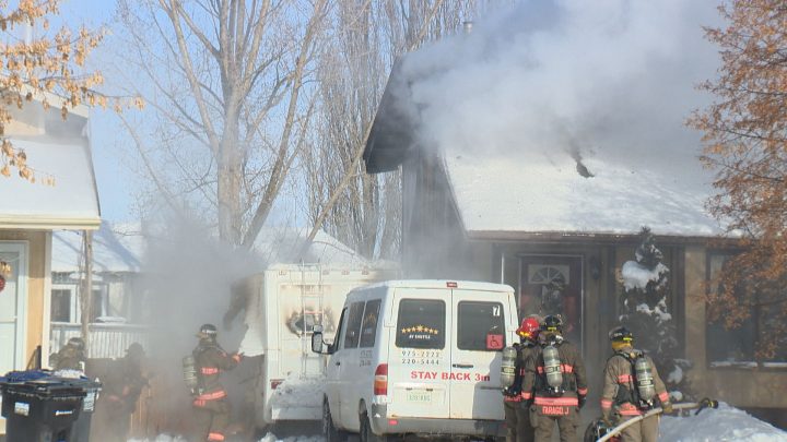 Flames spread from a recreational vehicle into the attic of a house in the Dundonald neighbourhood in Saskatoon on Thursday. 