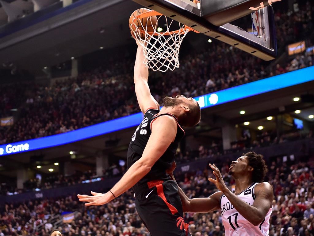 Toronto Raptors Marc Gasol makes a reverse dunk as Brooklyn Nets forward Ed Davis (17) looks on during second half NBA basketball action in Toronto on Monday, Feb. 11, 2019. THE CANADIAN PRESS/Frank Gunn