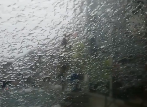 Freezing rain covers a windshield. 