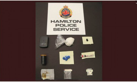 Hamilton police say officers chased the suspect and saw him discard a red bag behind a garage, which allegedly contained a black pellet gun, crystal meth, blue heroin, fentanyl and drug paraphernalia.