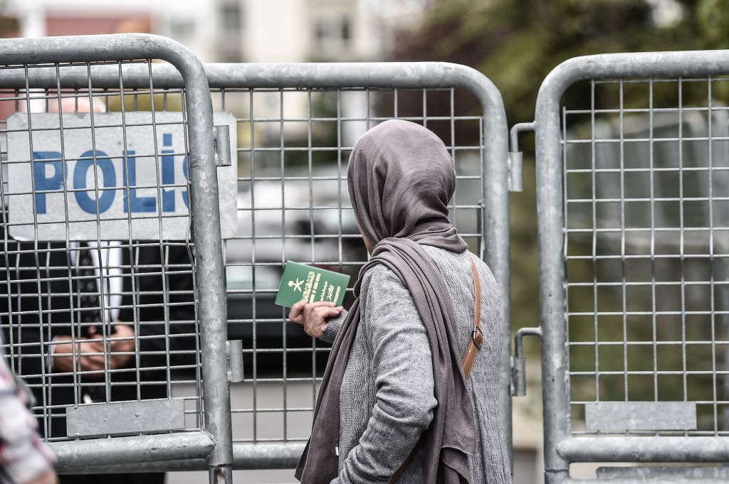 A Saudi woman gives her passport to a staff of the Saudi Arabian consulate on October 8, 2018 in Istanbul.