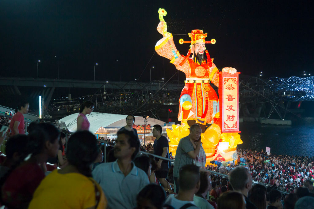 An illuminated sculture of the God of Fortune can be seen at Marina Bay Sands on the first day of Lunar New Year of the pig on February 5, 2019 in Singapore.