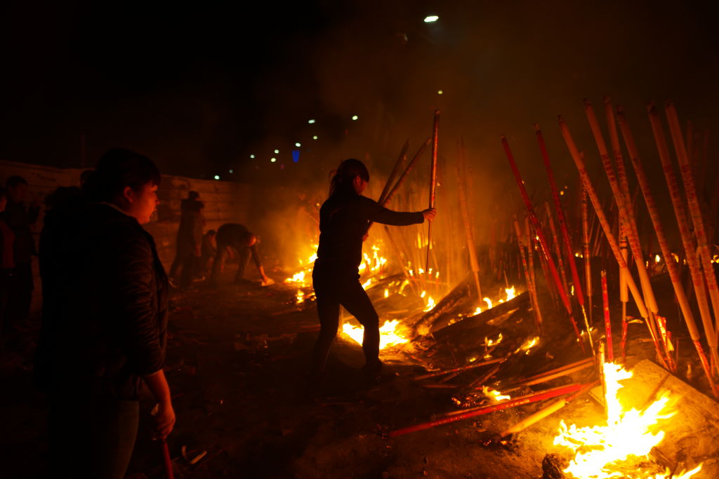 People burn incense sticks as they pray for good luck at Grand Buddha Temple on February 4, 2019 in Chongqing, China.