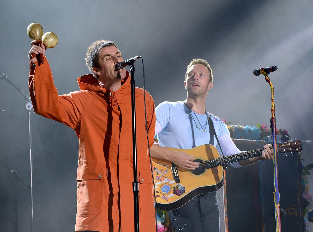 Liam Gallagher (L) and Chris Martin of Coldplay perform on stage during the ‘One Love Manchester’ benefit concert at Old Trafford Cricket Ground on June 4, 2017 in Manchester, England.