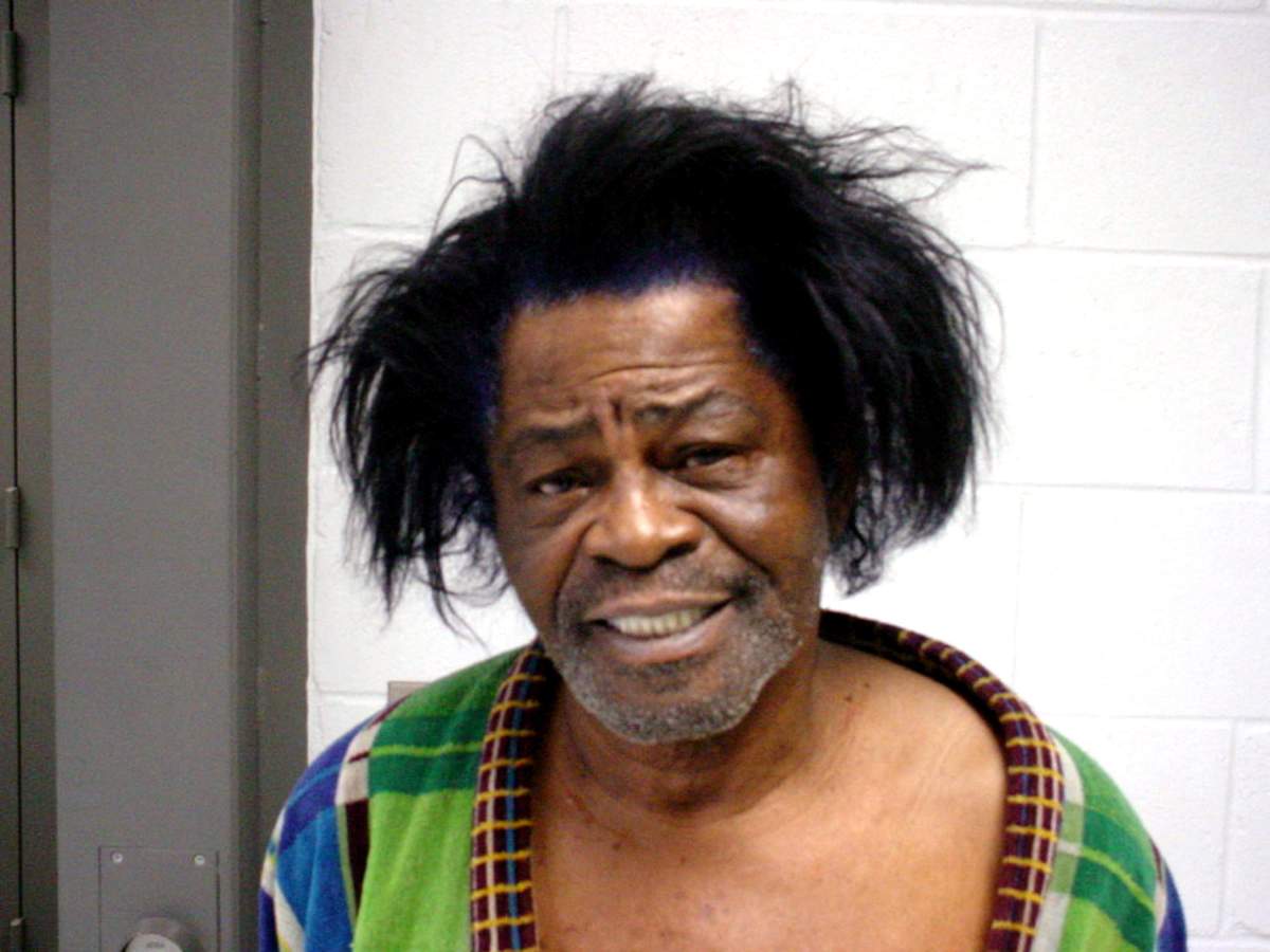 James Brown is arrested on Wednesday, Jan. 28, 2004, after he allegedly pushed his wife, Tomi Rae Brown, to the floor during an argument.