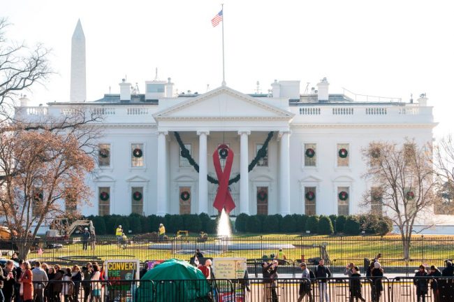 A red ribbon in recognition of World AIDS Day hangs from the North Portico of the White House in Washington, D.C, Dec. 1, 2017.