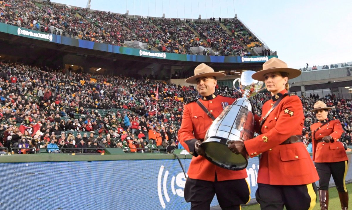 Members of the RCMP carry in the Grey Cup trophy at the beginning of the 106th Grey Cup between the Calgary Stampeders and Ottawa Redblacks at Commonwealth Stadium in Edmonton, Sunday, Nov. 25, 2018.