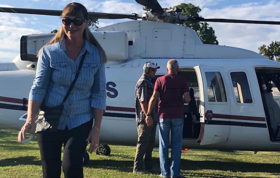 Heather Rodin of Hope Grows Haiti boards a helicopter at the compound on Tuesday morning.