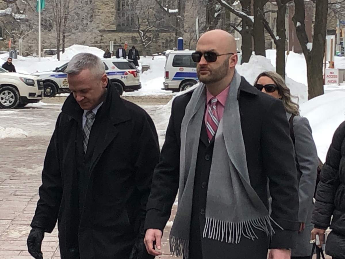 Daniel Montsion (right) makes his way into the Ottawa court house on Feb. 4. Montsion plead not guilty to manslaughter and assault charges stemming from the death of Abdirahman Abdi.