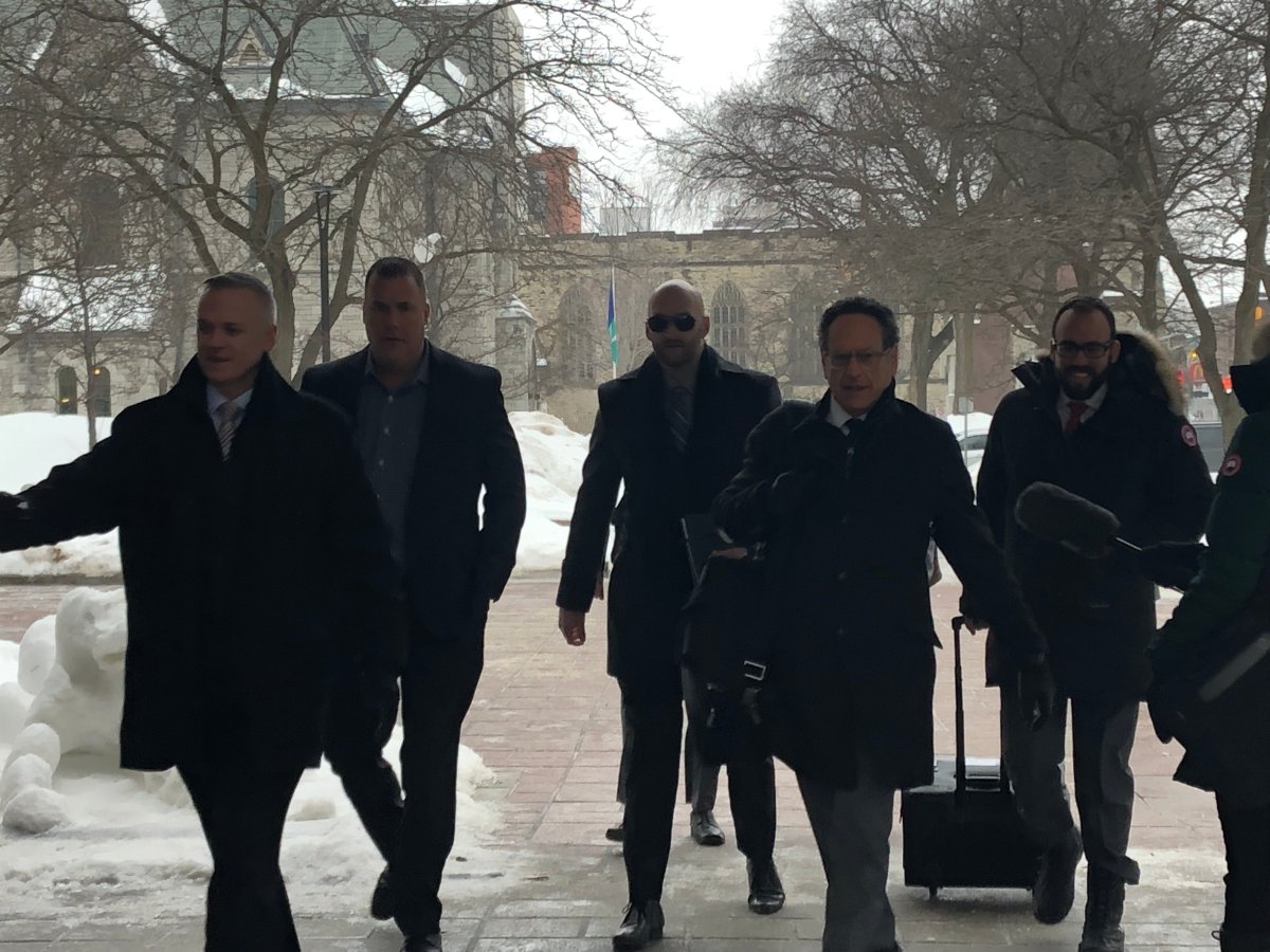Const. Daniel Montsion (centre) arrives at the Ottawa courthouse with his defence lawyers Michael Edelson (second from right) and Solomon Friedman (right) on Wednesday, Feb. 6. Montsion's manslaughter trial has been adjourned until Feb. 25 over new video evidence disclosed on the eve of trial.