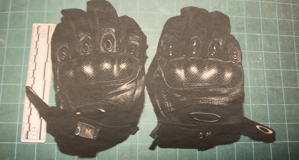 An evidence photo of the knuckle-plated, Oakley 'assault gloves' Const. Daniel Montsion was wearing during a confrontation with Abdirahman Abdi in July 2016.