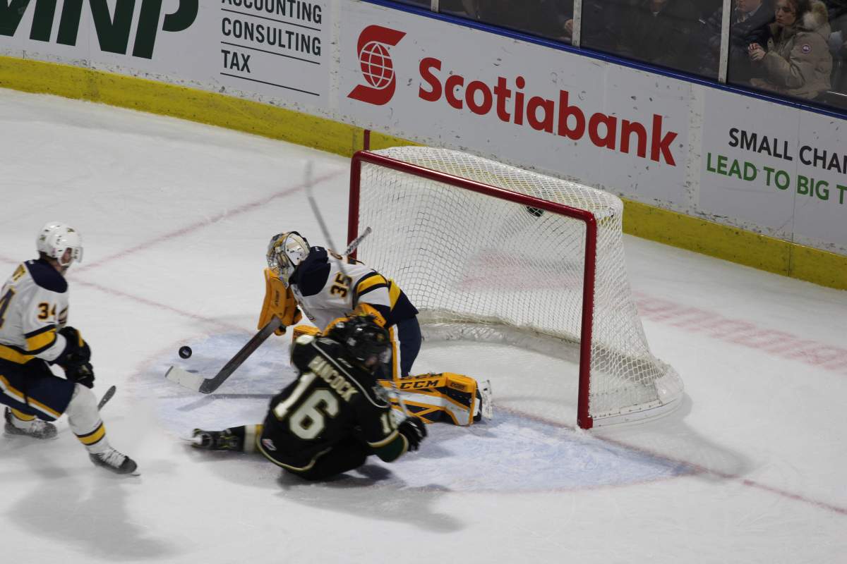 London, Ont. - Kevin Hancock of the London Knights gets stopped on the doorstep by Cole Ceci of Erie in a 4-3 overtime win by the Otters at Budweiser Gardens on February 15, 2019.