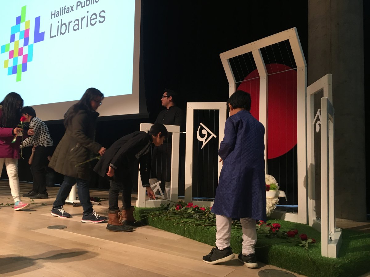 Members of the Bangladeshi community in Halifax places roses at a memorial for those who died supporting the Bengali Language Movement during International Mother Language Day celebrations on Feb. 24, 2019.