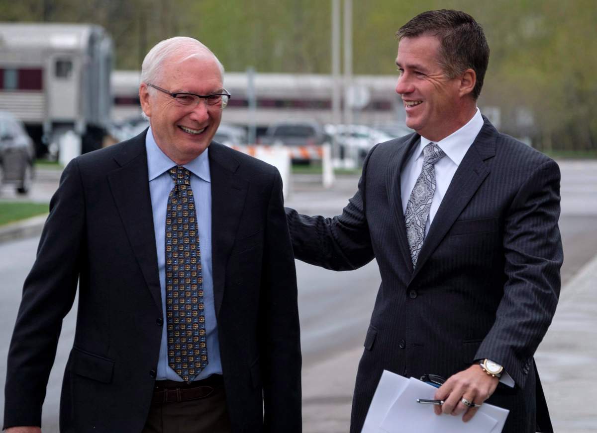 CP Rail president and CEO Keith Creel, right, greets a shareholder outside the company’s annual meeting in Calgary, Thursday, May 10, 2018.