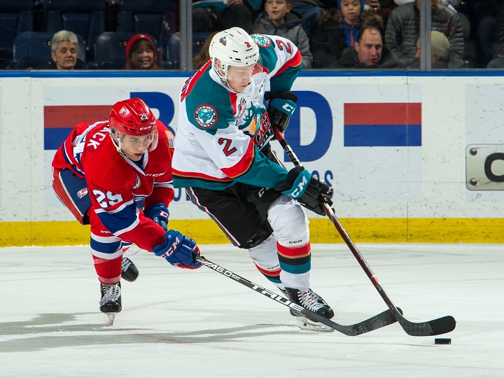 Lassi Thomson of the Kelowna Rockets carries the puck while Eli Zummack of the Spokane Chiefs tries defending him during WHL action on Wednesday night in Kelowna. Spokane won 5-43.