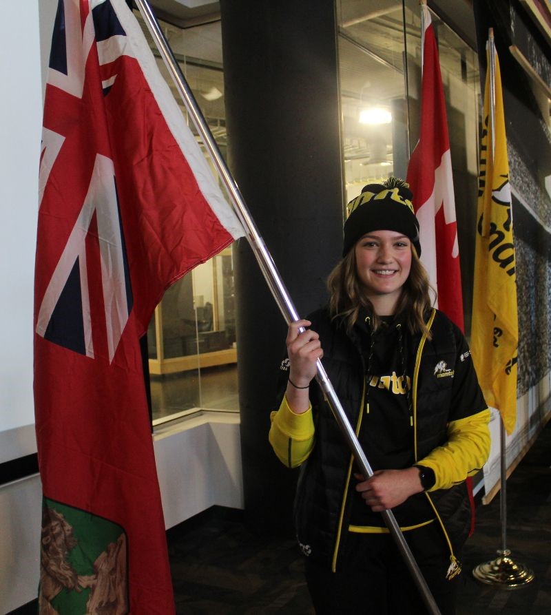 Alana Lesperance carries the Manitoba flag after being named flag bearer for the Canada Winter Games.