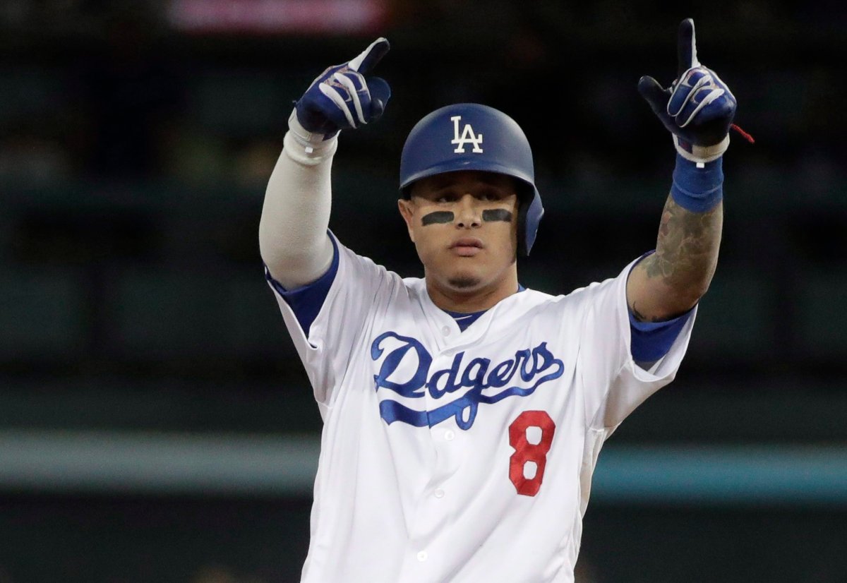 Los Angeles Dodgers' Manny Machado reacts after hitting a double during the first inning of Game 3 of the National League Championship Series baseball game Monday, Oct. 15, 2018, in Los Angeles.