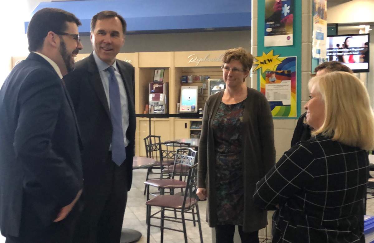 Federal Finance Minister Bill Morneau speaks with officials at the Guelph YMCA on Thursday.