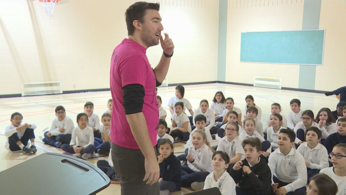 Travis Price speaks to students at General Vanier Elementary School about bullying.  (Global News).