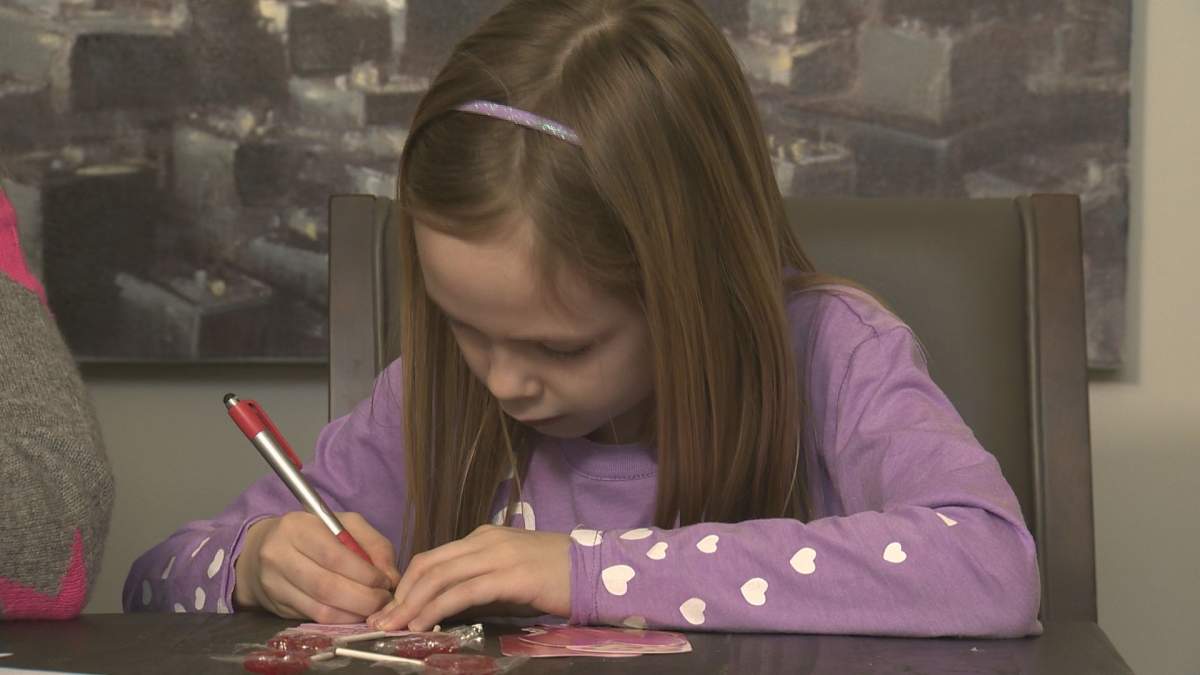 7-year-old Quinn Sexsmith puts the final touches on her school valentine cards.