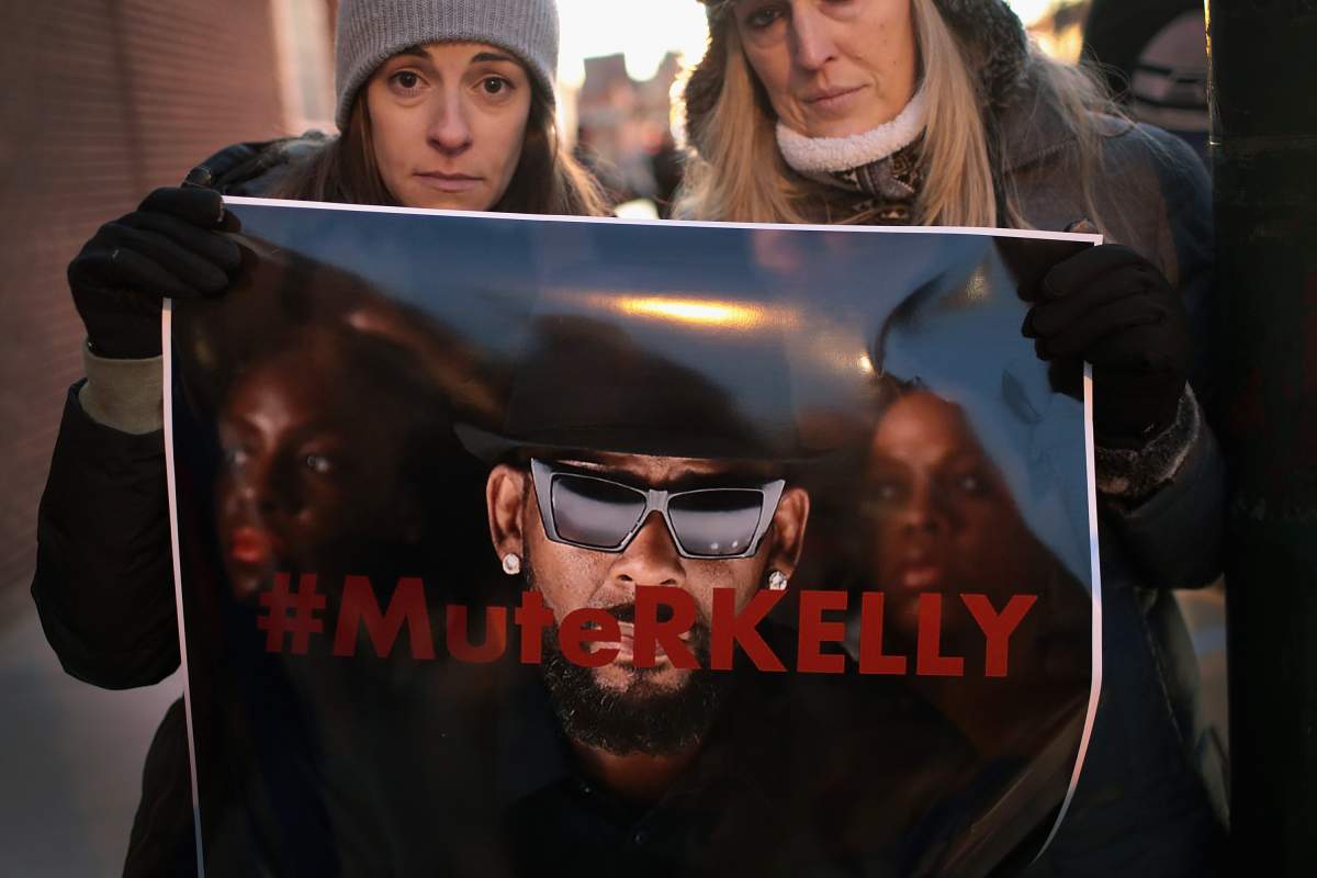 Demonstrators gather near the studio of singer R. Kelly to call for a boycott of his music on Jan. 9, 2019, in Chicago, Ill.