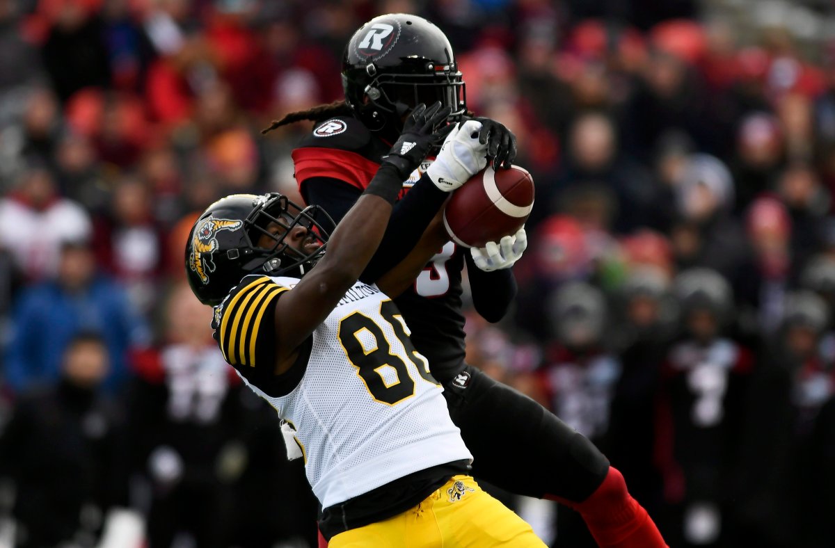 Ottawa Redblacks' Rico Murray (3) gets his hands on the ball as Hamilton Tiger-Cats' Bralon Addison (86) fails to catch it during first-half CFL East Division Final football game action in Ottawa, Ontario, Sunday, Nov. 18, 2018.