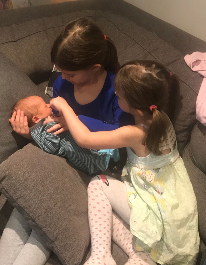 Brooke Seal’s daughters playing with their new baby brother.