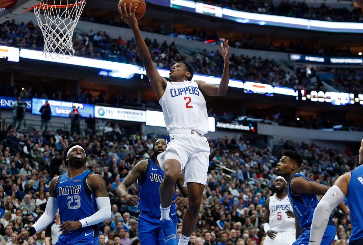 L.A. Clippers guard Shai Gilgeous-Alexander (2) drives to the basket against Dallas Mavericks defenders Wesley Matthews (23), DeAndre Jordan, back, and Dennis Smith Jr. (1) during the first half of an NBA basketball game in Dallas, Tuesday, Jan. 22, 2019.