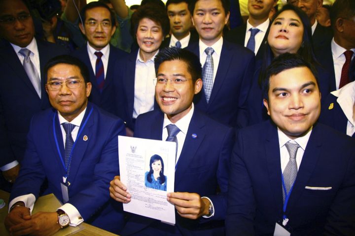 In this Feb. 8, 2019, file photo, the leader of Thai Raksa Chart party Preecha Pholphongpanich, center, holds a picture of Princess Ubolratana at election commission of Thailand in Bangkok, Thailand.