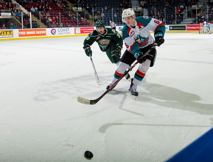 Kaedan Korczak of the Kelowna Rockets, front, passes the puck while Gage Goncalves of the Everett Silvertips pursues during WHL first-period action at Prospera Place in Kelowna, B.C., on Feb. 15, 2019. Everett won 3-1.