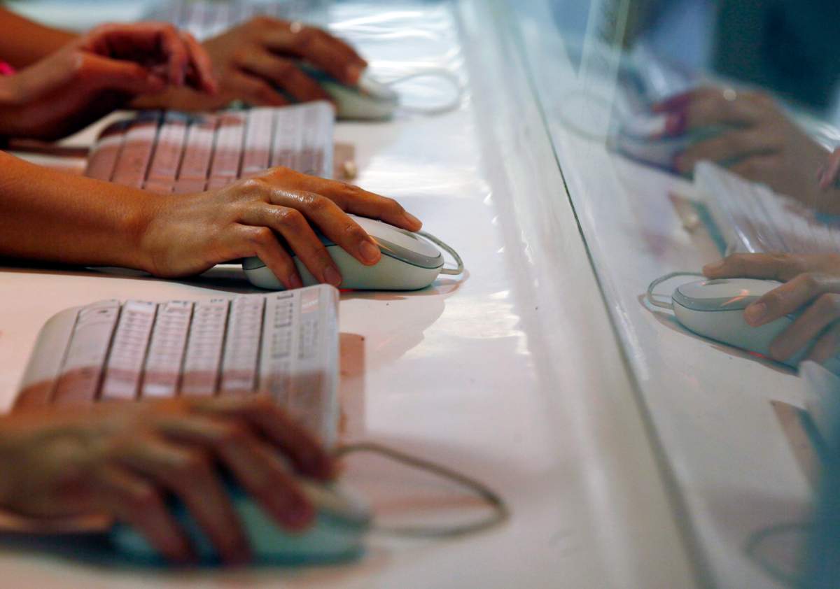 In this June 16, 2013 file photo, Internet users browse their Facebook website by the free wifi internet service in an underground station in Hong Kong. 