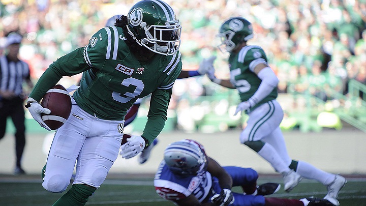 Saskatchewan Roughriders' defensive back Macho Harris, left, runs the ball for a touchdown after an interception against the Montreal Alouettes in Regina on Sept. 27, 2015. 