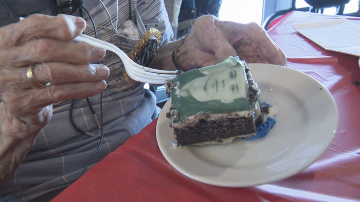 Clarence Hollingworth pointed out his 18-year-old self on his 104th birthday cake.