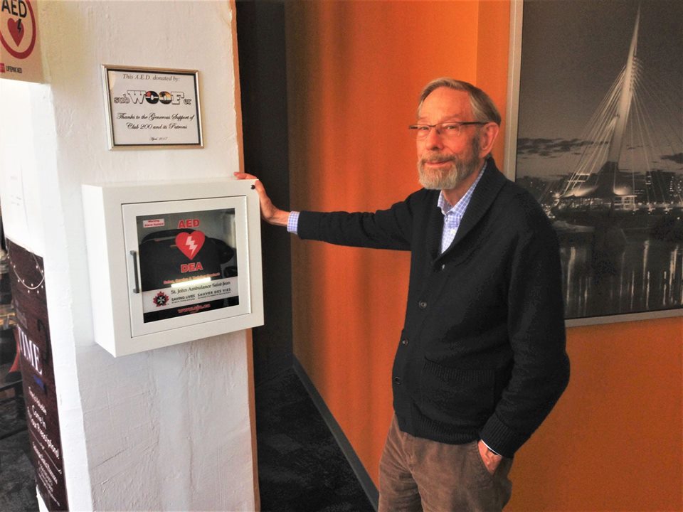 Dr. Dick Smith next to a new AED machine in his clinic in 2017.