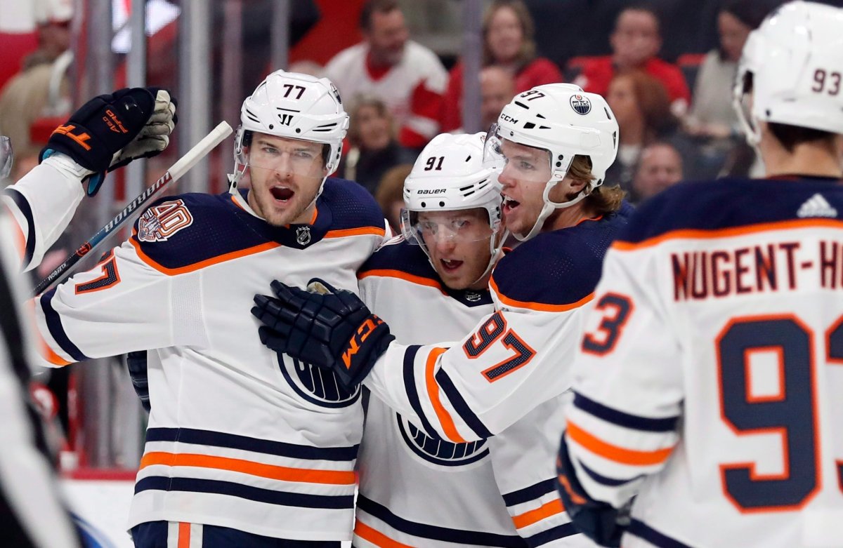 Edmonton Oilers left wing Drake Caggiula (91) is congratulated, after his goal, by teammates defenseman Oscar Klefbom (77), center Connor McDavid (97) and center Ryan Nugent-Hopkins (93) during the first period of an NHL hockey game against the Detroit Red Wings, Saturday, Nov. 3, 2018, in Detroit. (AP Photo/Carlos Osorio).