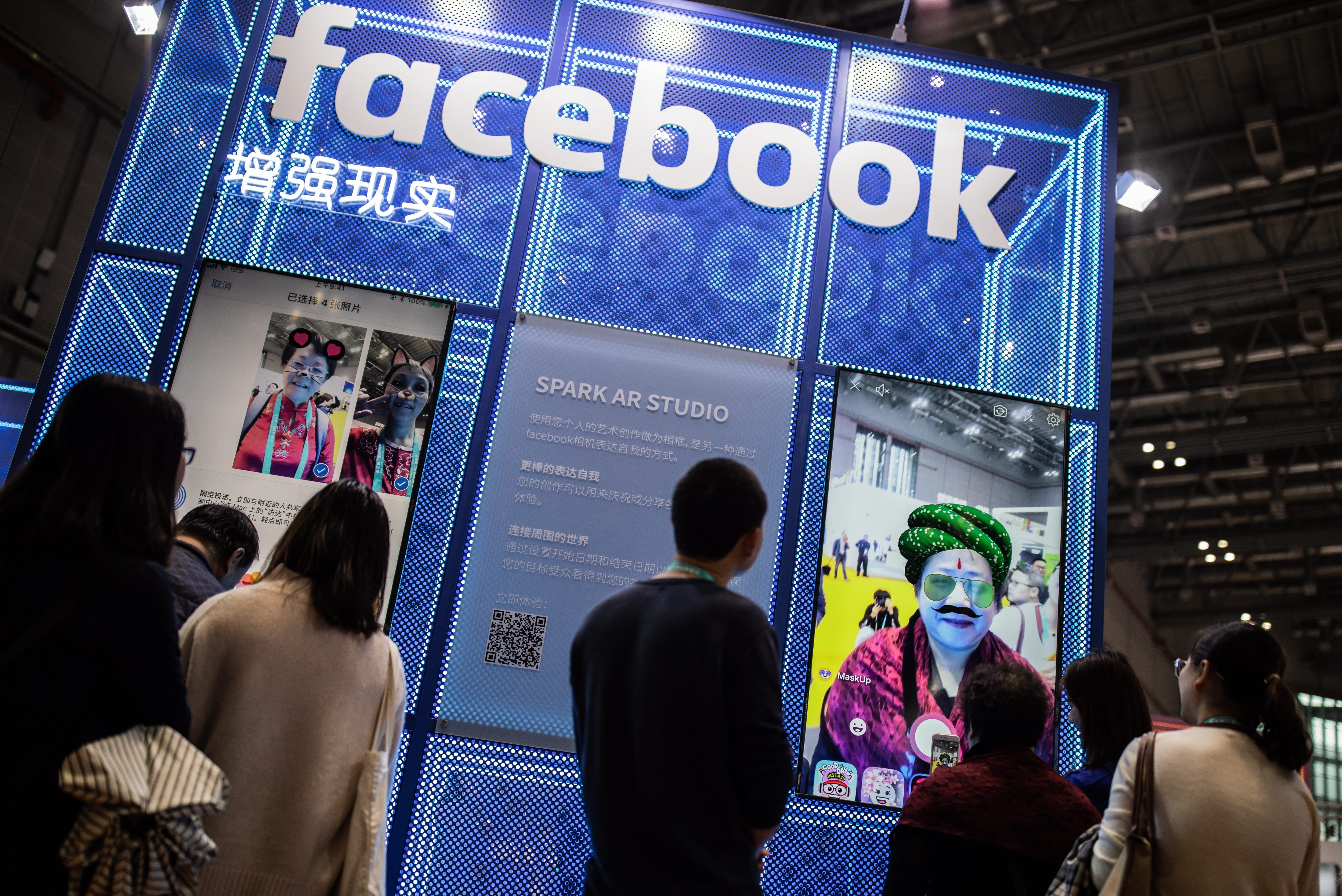 Visitors walk past a Facebook sign during the during China International Import Expo (CIIE) in Shanghai, China, 07 November 2018. 