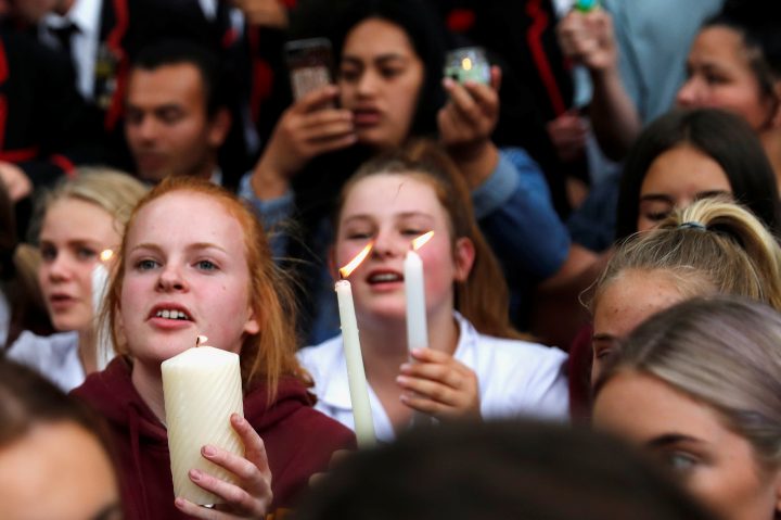 Students hold lit candles as they gather in a vigil to commemorate victims of Friday’s shooting, outside Masjid Al Noor mosque in Christchurch, New Zealand, March 18, 2019. 