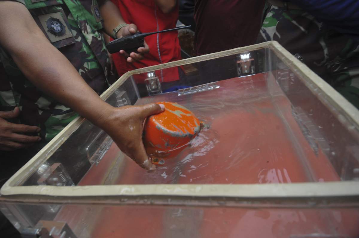 A cockpit voice recorder, the second black box of Lion Air flight 610, is taken out of water by Indonesian personnel in Karawang, West Java province of Indonesia, Jan. 14, 2019.