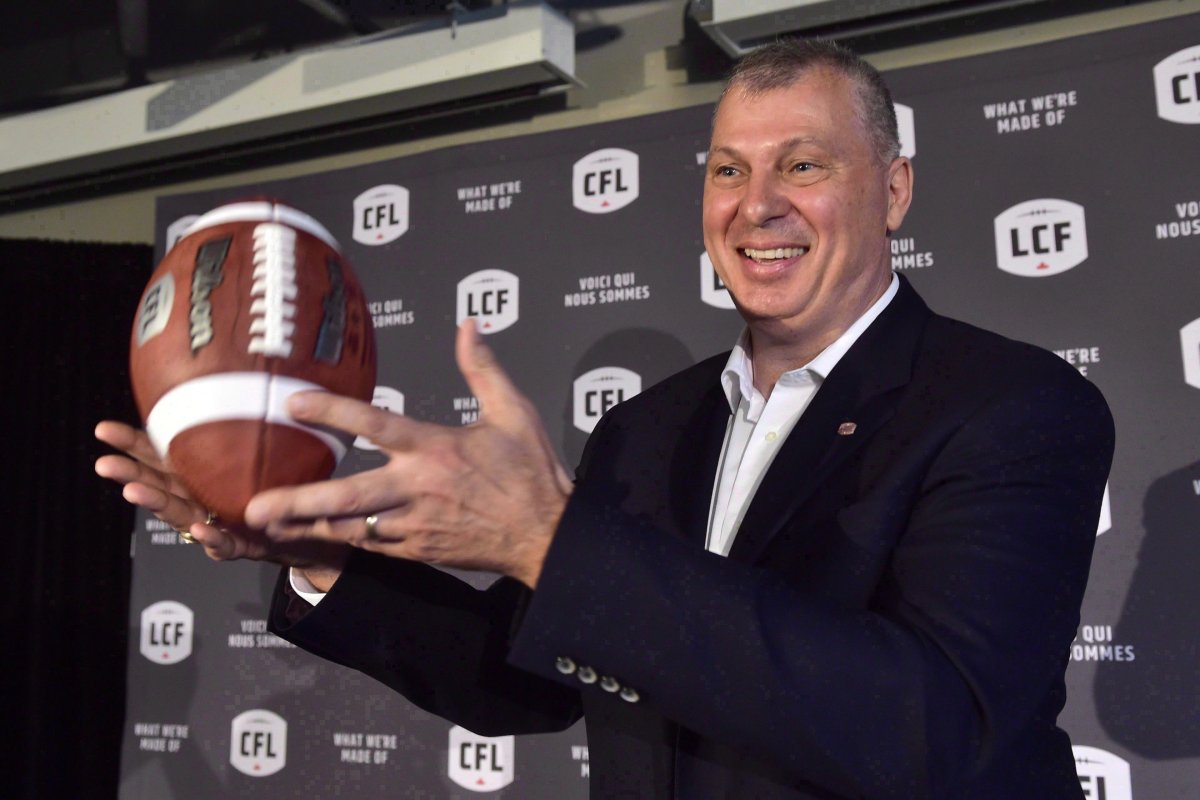 Randy Ambrosie tosses a football as he speaks during a press conference in Toronto on July 5, 2017. The CFL commissioner said Friday he'll be meeting football officials from Germany later this month to discuss the possibility of Canadian and German players suiting up in the respective circuits. 
