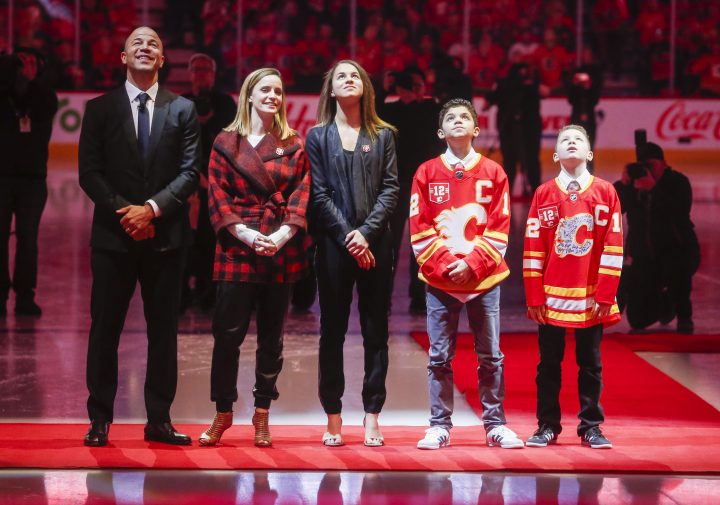 Former Calgary Flames captain Jarome Iginla, left, and his family look on as his number 12 jersey is retired prior to NHL hockey action in Calgary, Saturday, March 2, 2019.