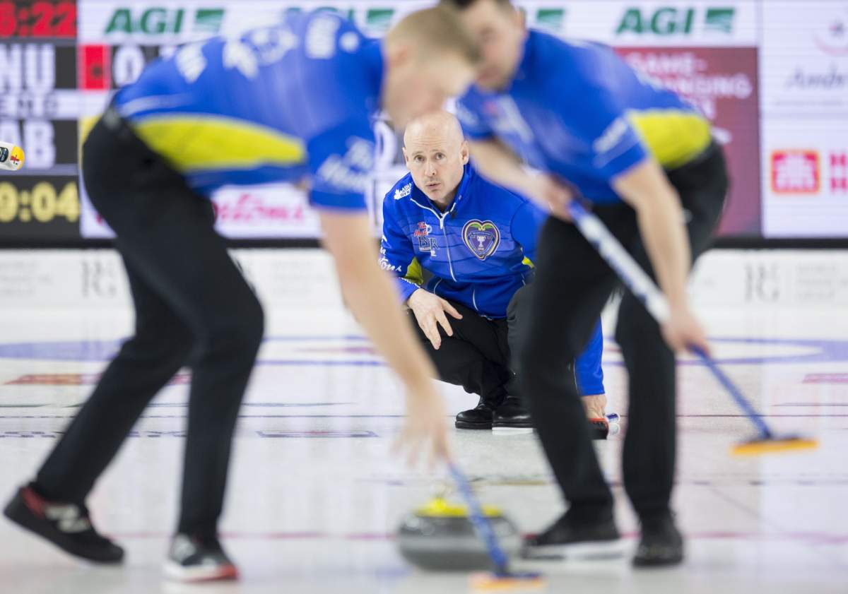 Team Alberta skip Kevin Koe looks on as lead Ben Hebert and second Colton Flasch sweep during the 12th draw against team Nunavut at the Brier in Brandon, Man. Wednesday, March 6, 2019.