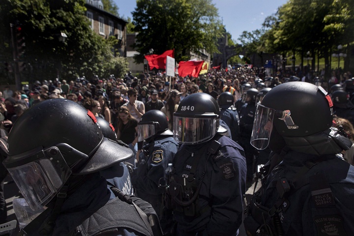 Protesters march through in Quebec City on Saturday, June 9, 2018, as the G7 summit closes. 