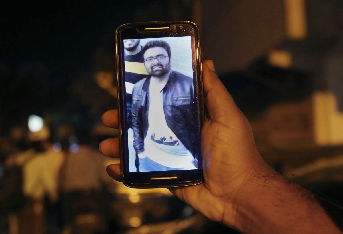 A relative shows the picture of Syed Areeb Ahmed, a Pakistani citizen who was killed in the Christchurch mosque shooting, on his cellphone outside his home in Karachi, Pakistan, Saturday, March 16, 2019.