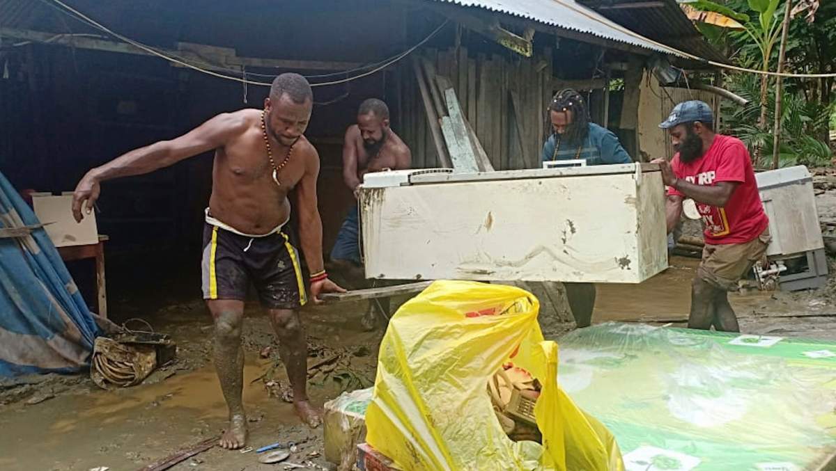 People clean the debris from a house in Sentani, Papua Province, Indonesia, Monday, March 18, 2019.