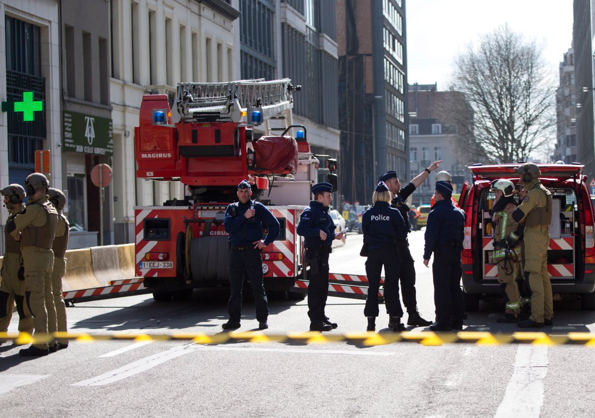 Members of emergency personnel and police stand behind a cordon as they respond to a bomb alert in the EU quarter of Brussels on Tuesday, March 19.