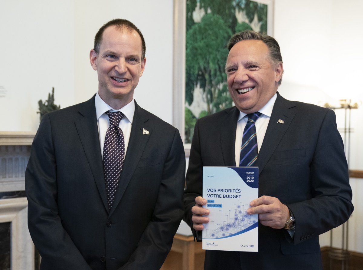 Quebec Premier François Legault receives a copy of the budget speech from Quebec Finance Minister Eric Girard, left, Thursday, March 21, 2019 at the premier's office in Quebec City. Girard will table his first budget since the election of a CAQ government. 