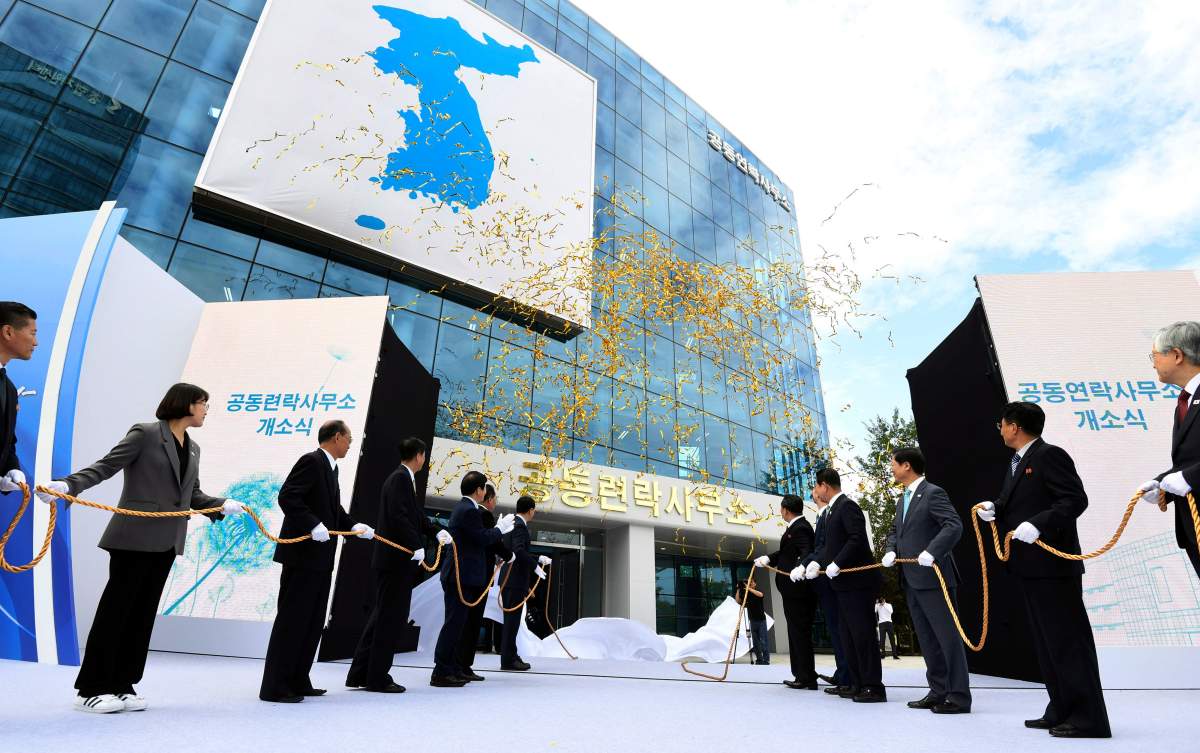 In this Sept. 14, 2018, file photo, South Korea's Unification Minister Cho Myoung-gyon, center left, and Ri Son Gwon, chairman of the North's Committee for the Peaceful Reunification, center right, attend at an opening ceremony for two Koreas' first liaison office in Kaesong, North Korea. 