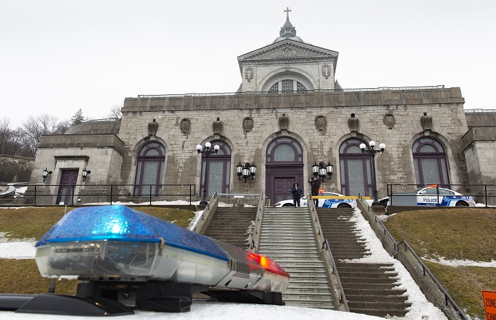 Police cars surround the St. Joesph's Oratory in Montreal after a Catholic priest was stabbed as he was celebrating mass at the oratory. on Friday, March 22, 2019 .